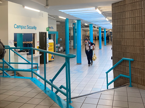 Our group found a lot of areas for improvement in this area. The ramp is only on one side of the stairs so a person would potentially need to go all the way around to to access them which  can be very inconvenient. The signage could also be improved. There could be colour-coded tiles on the floor or paint along the walls or symbols acting as a guide while the person is walking through the area. We also thought an interactive digital kiosk would be helfpul. Users can type where they want to go and could then receive visual step-by-step instructions. For our last improvement, we thought the display cases could showcase the students' work in a way that makes it stand out more and will cause people to stop and look at it. They could also post a digital monitor that has a slideshow of students' art. <a href='https://www.youtube.com/embed/tgbNymZ7vqY' target='_blank'><p>Project Video Link</p></a>